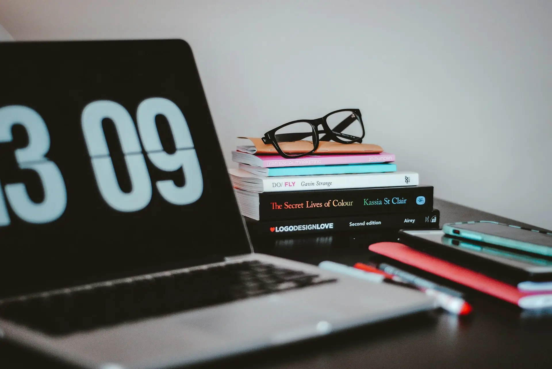 silver MacBook Pro near books